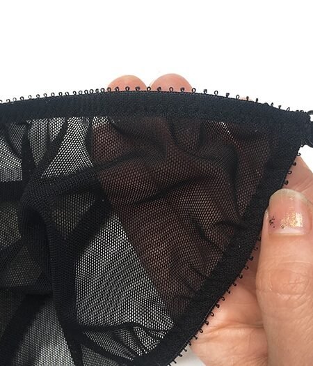 Sheer black panties with detailed edges