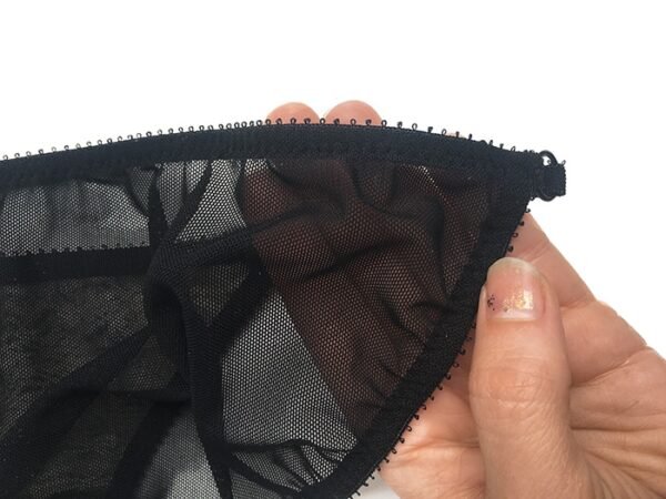 Sheer black panties with detailed edges