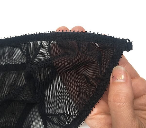Sheer black panties with detailed edges
