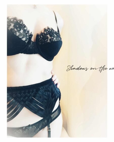Strappy black garter-belt and lace bra