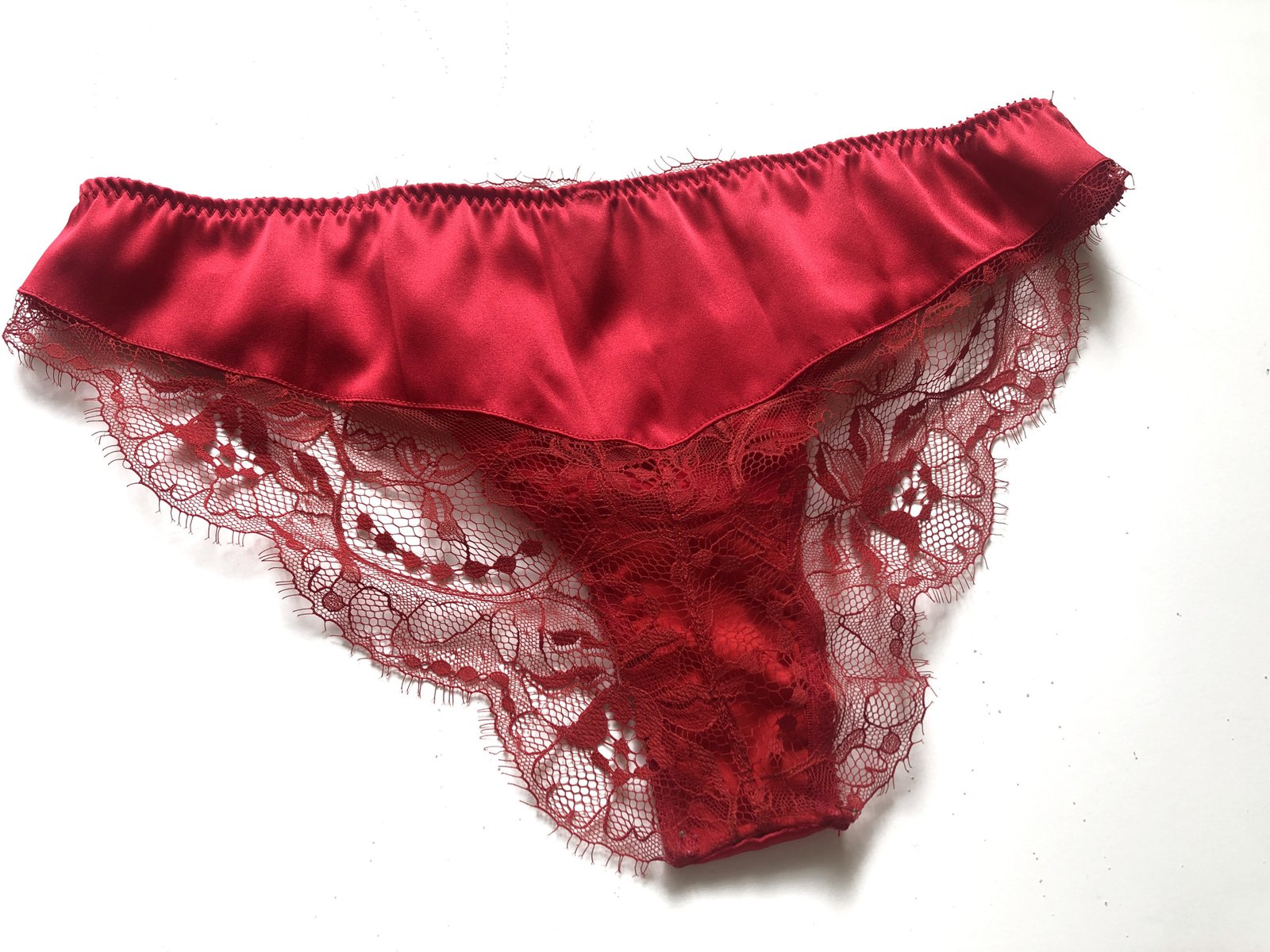 Photo of Lacy Underwear on Red Silky Fabric