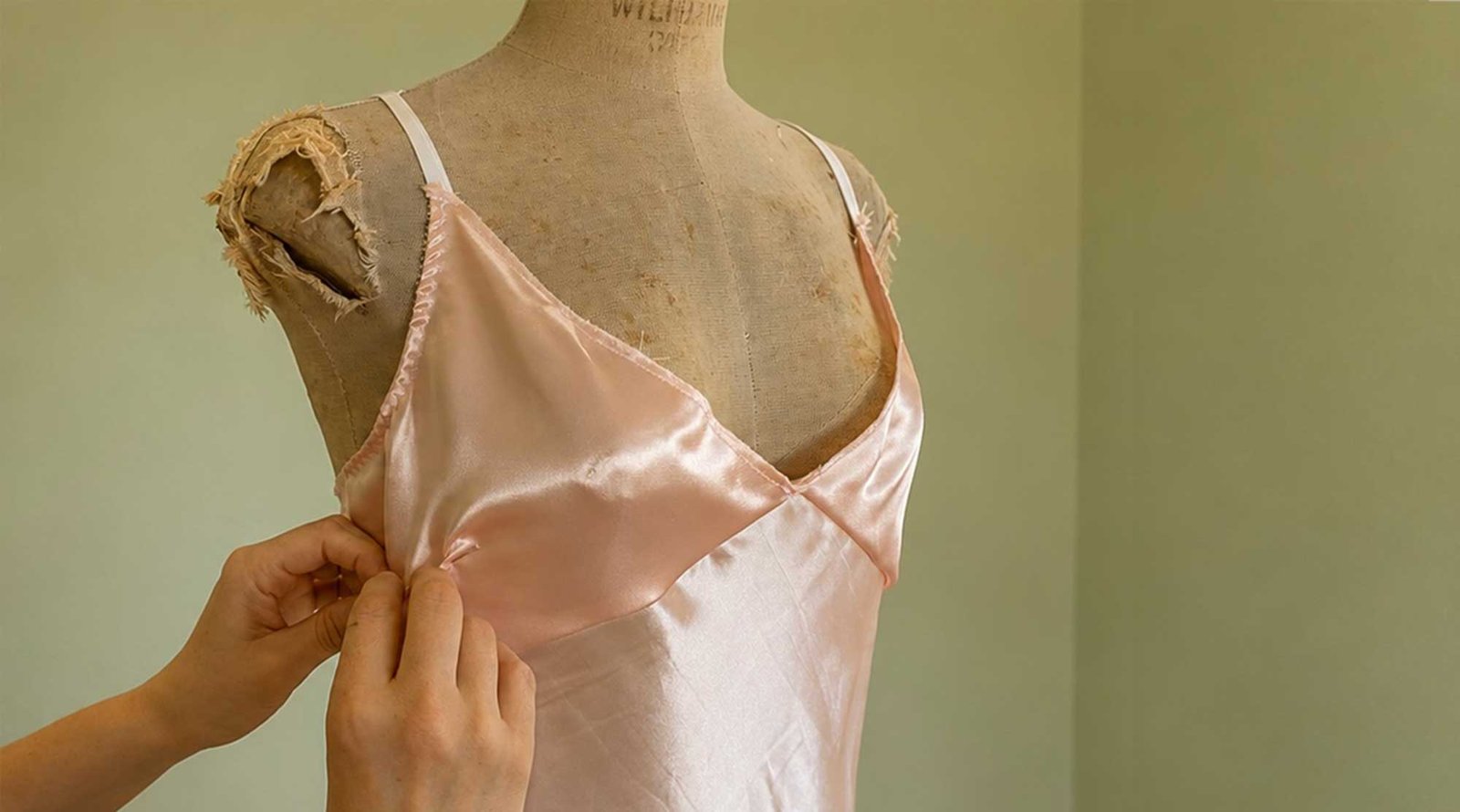 adjusting-bespoke-lingerie-prototype Adjusting a bespoke lingerie prototype with pins during the fitting process.